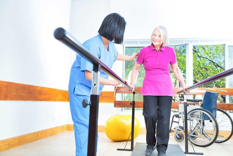 A person gently stretching their shoulder while seated at home, showing careful attention to posture and comfort.